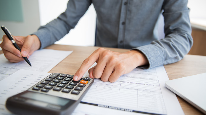 Tax preparation services expert in Queens consulting with a small business owner